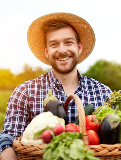 Great Lakes Community Conservation Corps Ag Veteran smiling with basket of harvested vegetables