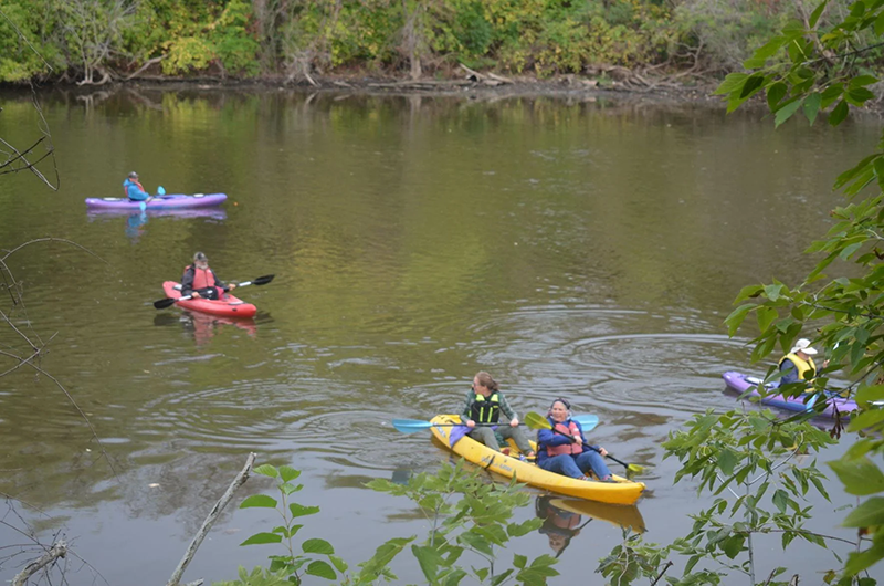 Overhead view from shore ofkayakers who are veterans kayaking in Root River in Racine,WI