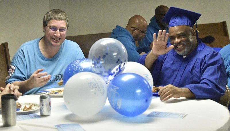 Great Lakes CCC veteran corps member John Grube, left, and graduate Travis Gardner smile for a photo during lunch, a part of the graduation ceremony Wednesday for Racine and Milwaukee Great Lakes CCC CERT School students at City on a Hill, 910 N. 23rd St., Milwaukee. Rachel Kubik